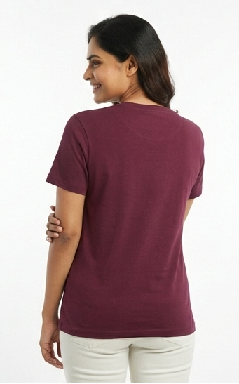 Woman wearing a maroon t-shirt on a white background