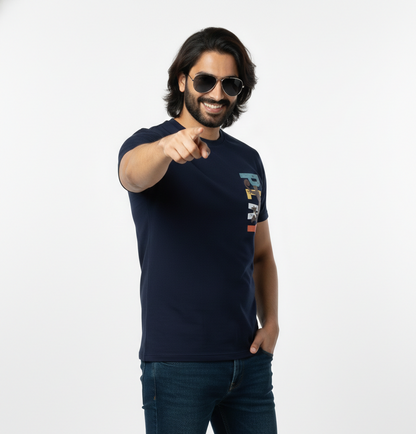 Man wearing a navy blue t-shirt with colorful text design on a white background