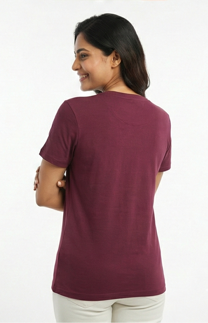 Woman wearing a maroon t-shirt on a white background