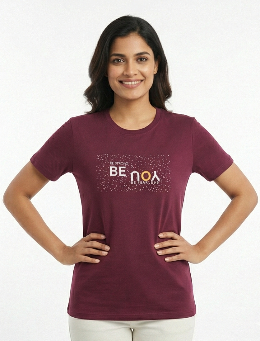Woman wearing a maroon t-shirt with text on a white background