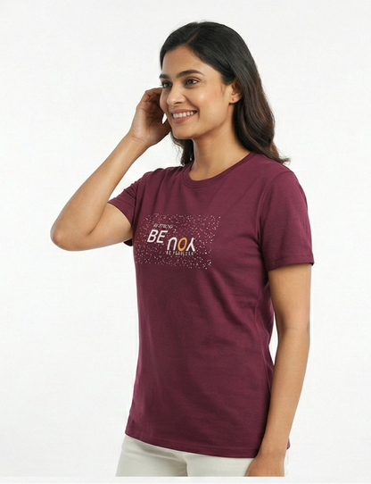 Woman wearing a maroon t-shirt with text on a white background