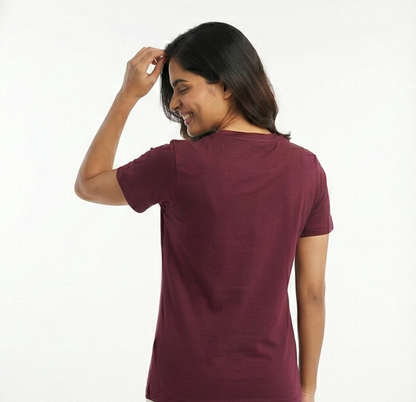 Woman wearing a maroon t-shirt on a white background