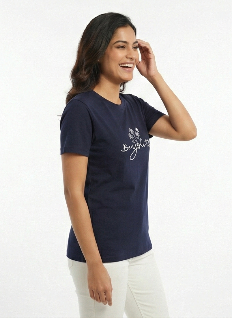 Woman wearing a navy blue t-shirt with text on a white background