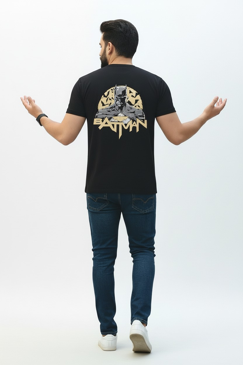 Person wearing a black t-shirt with a Batman logo on a white background