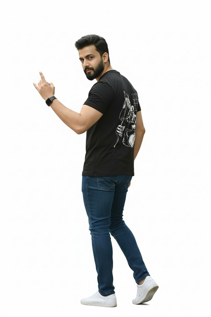 Man wearing a black t-shirt with a graphic design, blue jeans, and white sneakers on a white background