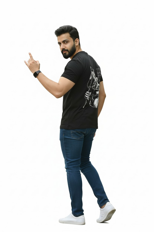 Man wearing a black t-shirt with a graphic design, blue jeans, and white sneakers on a white background